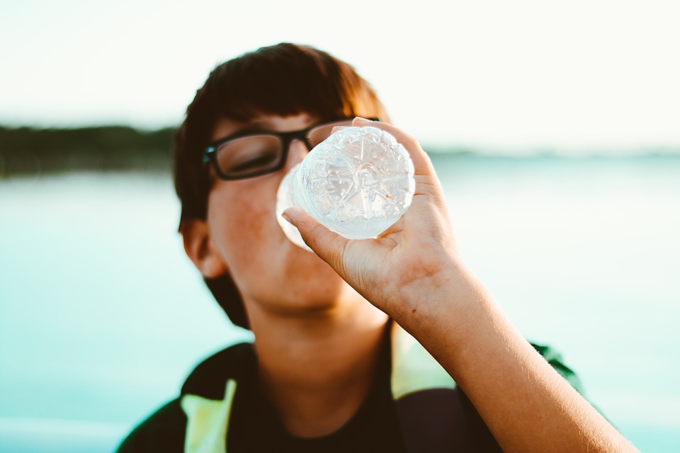 A person drinking a bottled water